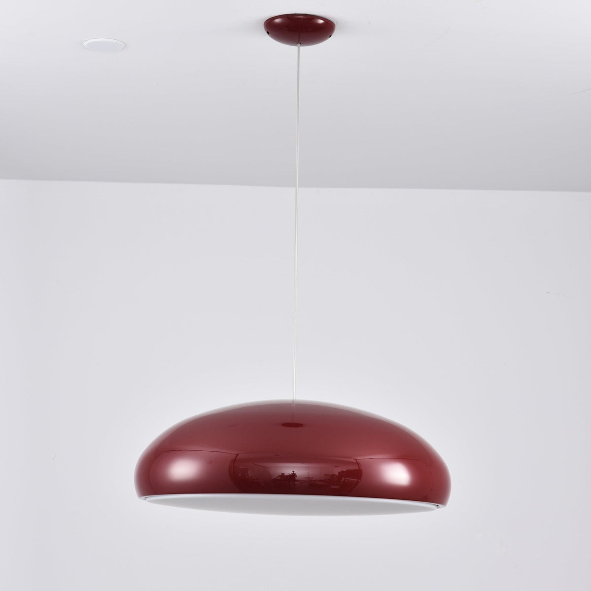 Dark-red Clérachic dome pendant seen from slightly below, its pale inner shade just visible under the shell.