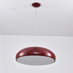 Dark-red Clérachic dome pendant viewed from beneath, with an unlit grey diffuser disc closing the shade.