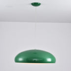 Green Clérachic dome pendant with a glossy shell, hung from a matching green canopy against a white wall.