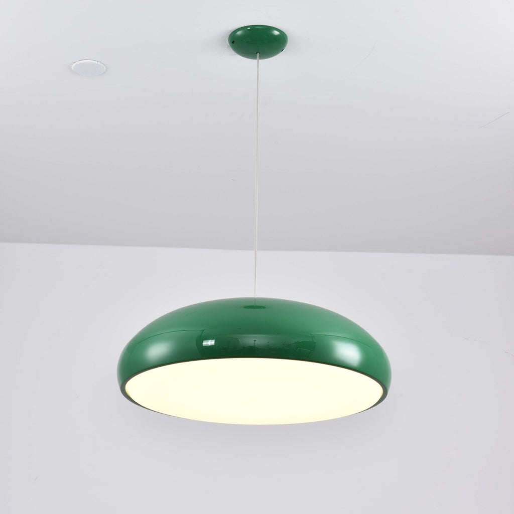 Green Clérachic dome pendant lit and seen from slightly below, with a spotlight in the white ceiling above.