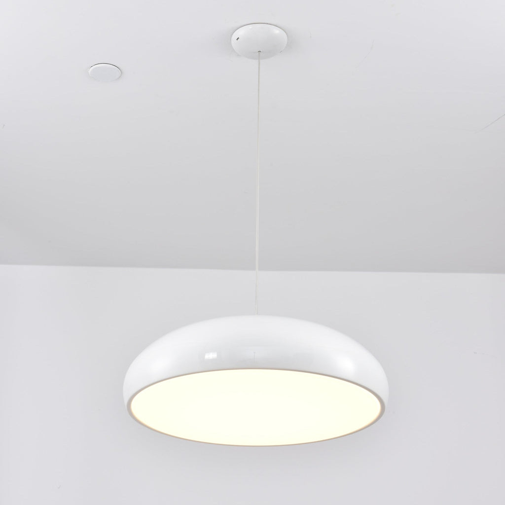 A white Clérachic dome pendant with a bright cream diffuser, hung from a white canopy under a white ceiling.