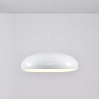 White Clérachic dome pendant, side view, with a glossy shell and a soft glow under its rim.
