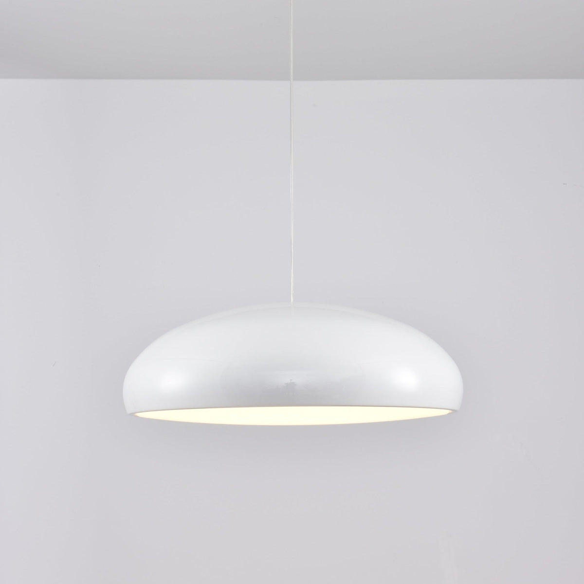 White Clérachic dome pendant, side view, with a glossy shell and a soft glow under its rim.