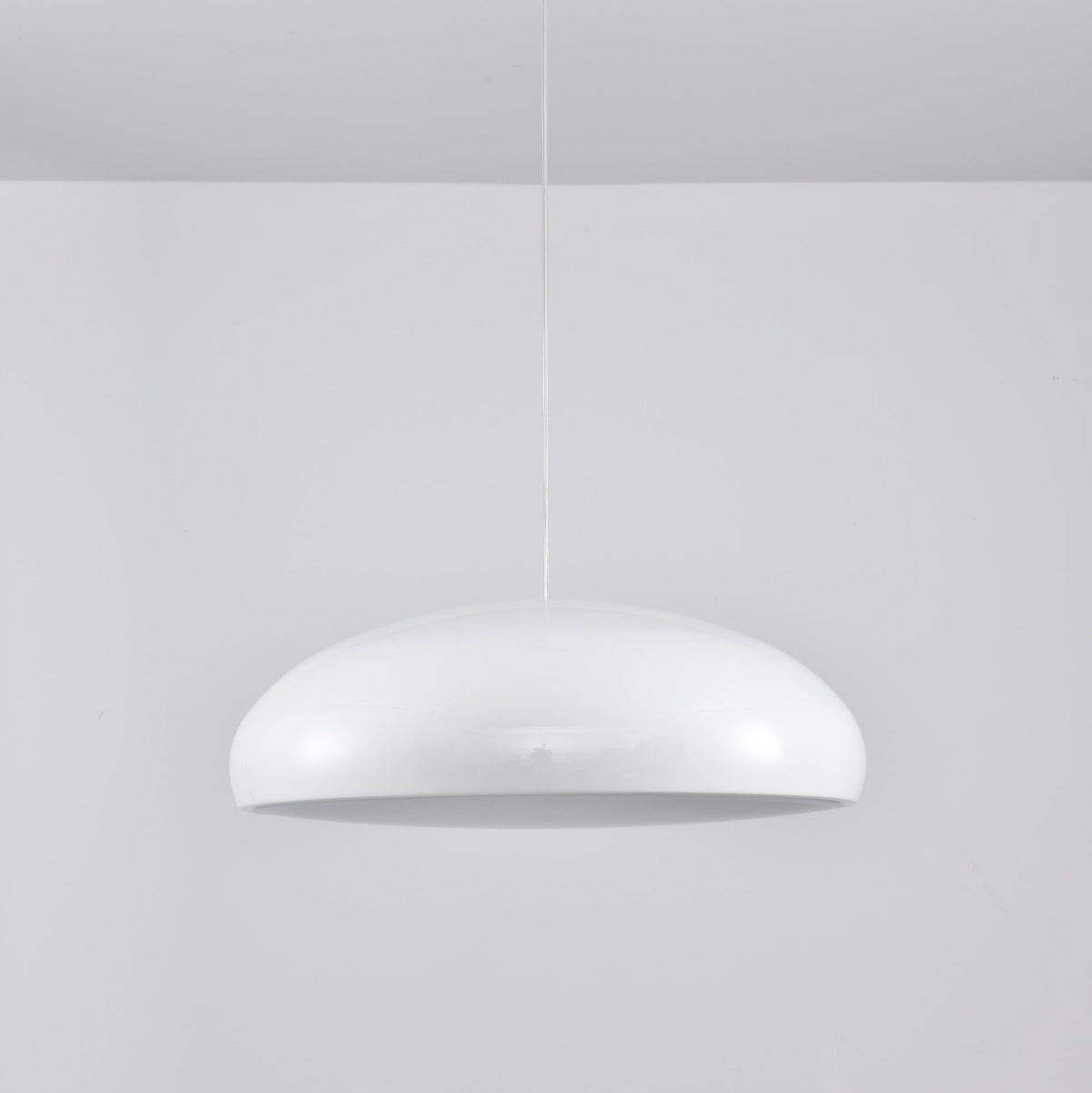 White Clérachic dome pendant viewed from slightly below, its grey inner disc unlit and its shell glossy.