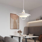 In a dining corner with a banquette and an abstract print, a white Clérachic pendant hangs low over a small table.