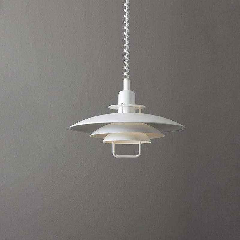 White Clérachic pendant on a mid-grey backdrop, its three round shades stacked beneath a white coiled cable.