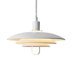 White Clérachic pendant on a pale backdrop, glowing from inside, with a white loop handle beneath the lowest tier.