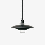 Black Clérachic pendant on a pale grey backdrop, with a black cable and a metal loop handle under the bottom shade.
