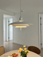 White Clérachic pendant in a hallway with a round table and yellow flowers, its light a soft warm glow.