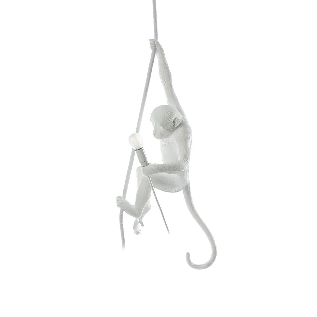 Slim white monkey on a thin rope, one arm up and a bulb holder in hand, floating on a plain white backdrop; this Clérachic pendant.