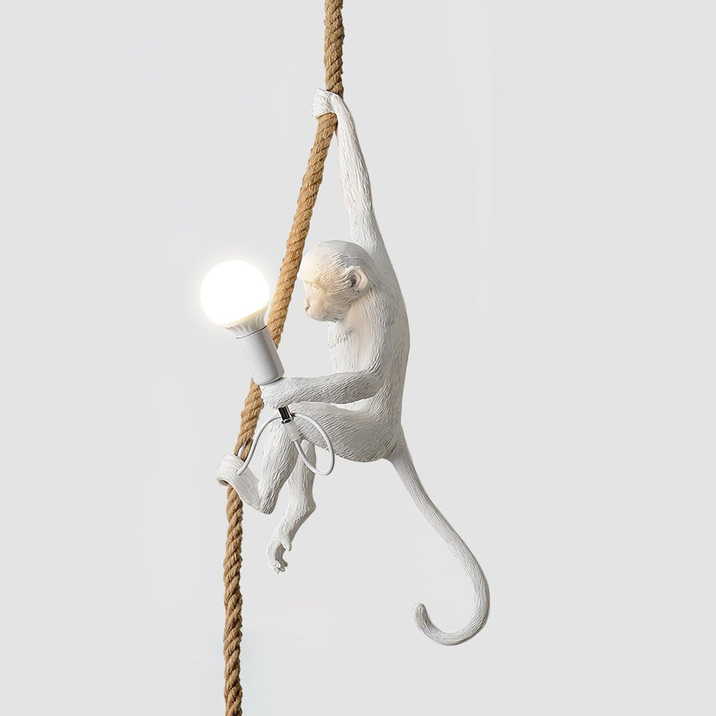 White monkey with a round bulb lit in its hand, climbing a natural rope against a soft grey background; this Clérachic pendant.