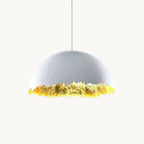 Clérachic pendant with a pale domed shade and a jagged, gold-leaf lower edge, hung on a thin cord against a white backdrop.