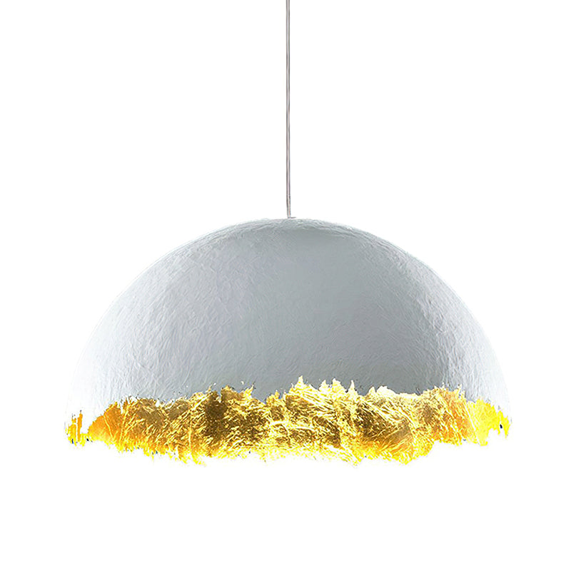 The widest version of this Clérachic dome pendant, with a pale textured shell and gold leaf along its jagged rim.