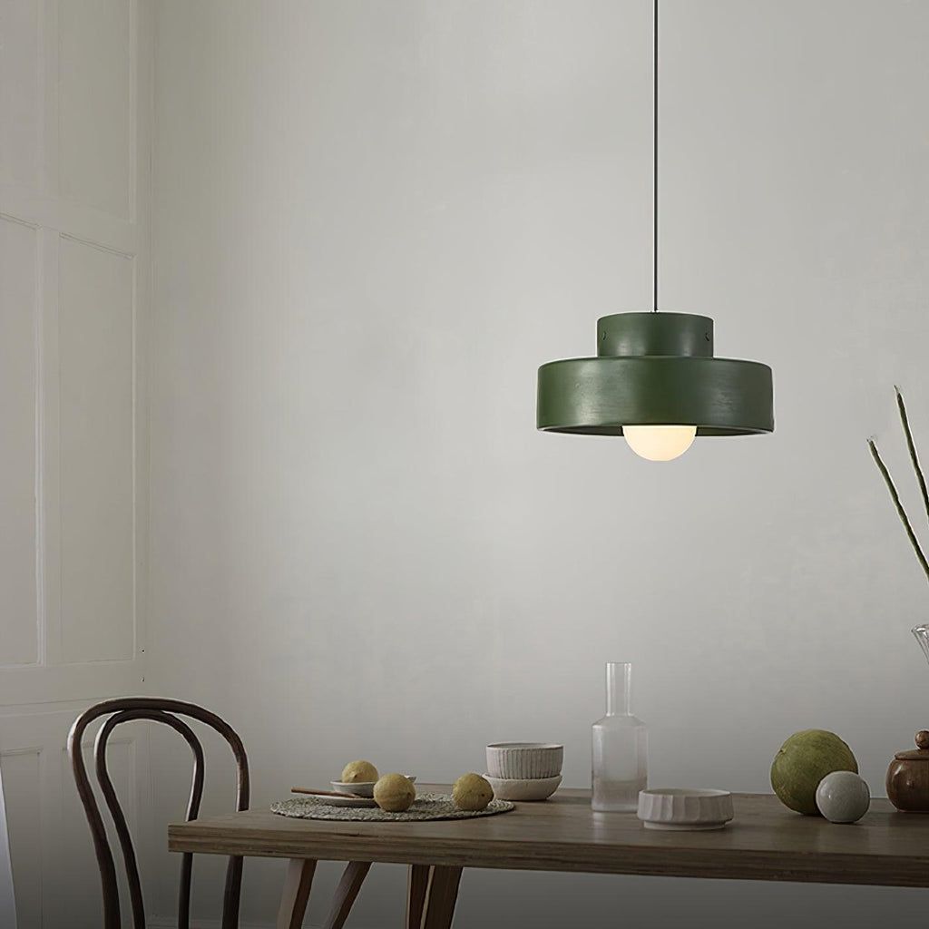 Green version of this Clérachic pendant above a wooden table set with bowls, glasses and fruit, with a bentwood chair at the side.