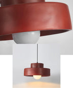 Two views in one frame: a close crop of the red resin shade and bulb, and a small full view of this Clérachic pendant.