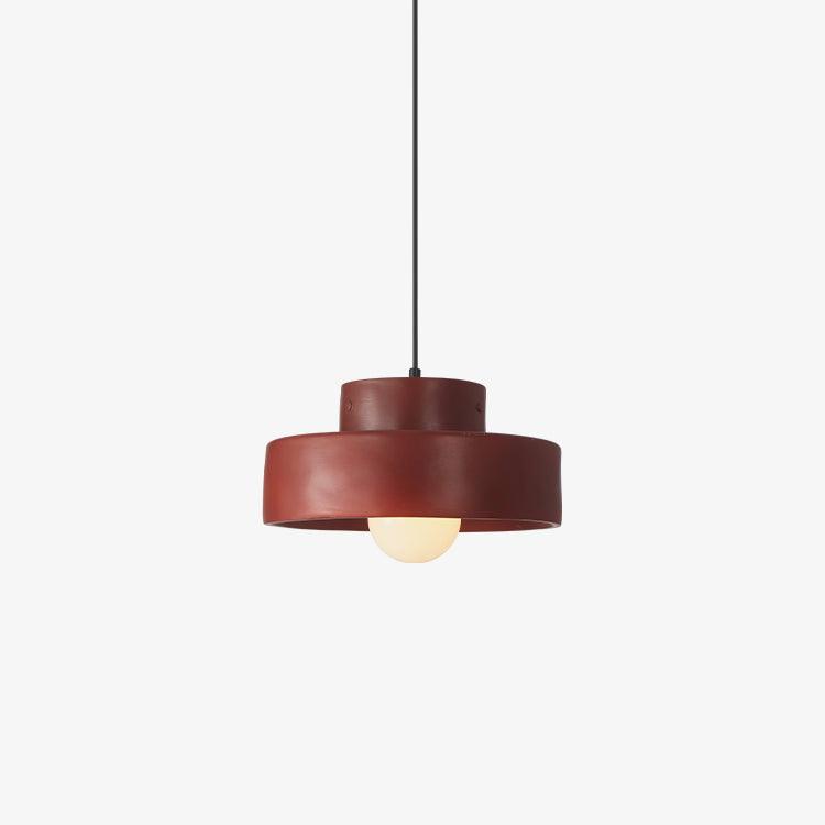 Red stepped-drum Clérachic pendant on a light backdrop, with a rounded frosted bulb sitting just below the rim.