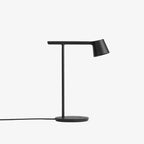 A Clérachic table lamp in black, centred on a white backdrop, with a flat round base and a thin dark cord.