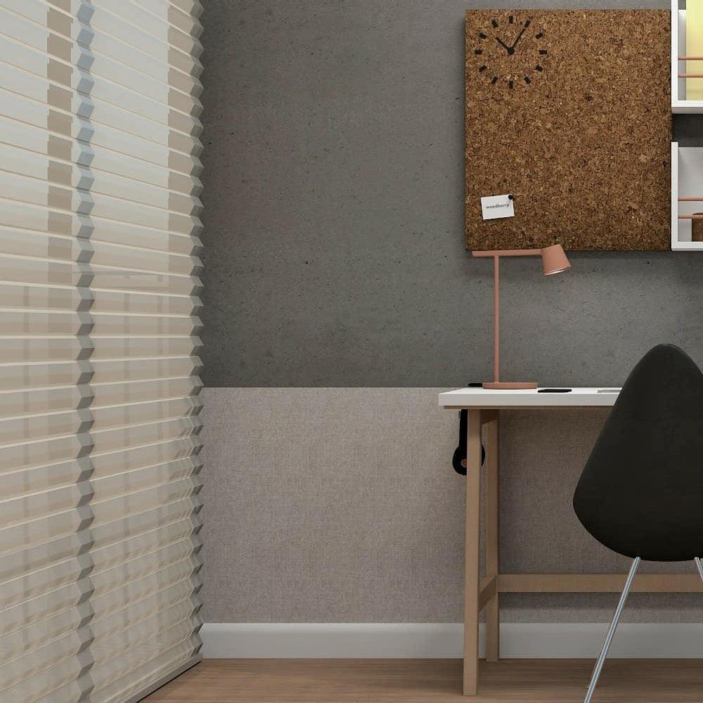 Small rust-red Clérachic table lamp on a narrow white desk, with a cork board on the wall and window blinds beside it.