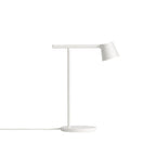 A white Clérachic table lamp against a white backdrop, with its angled head and white cord lying on the surface.