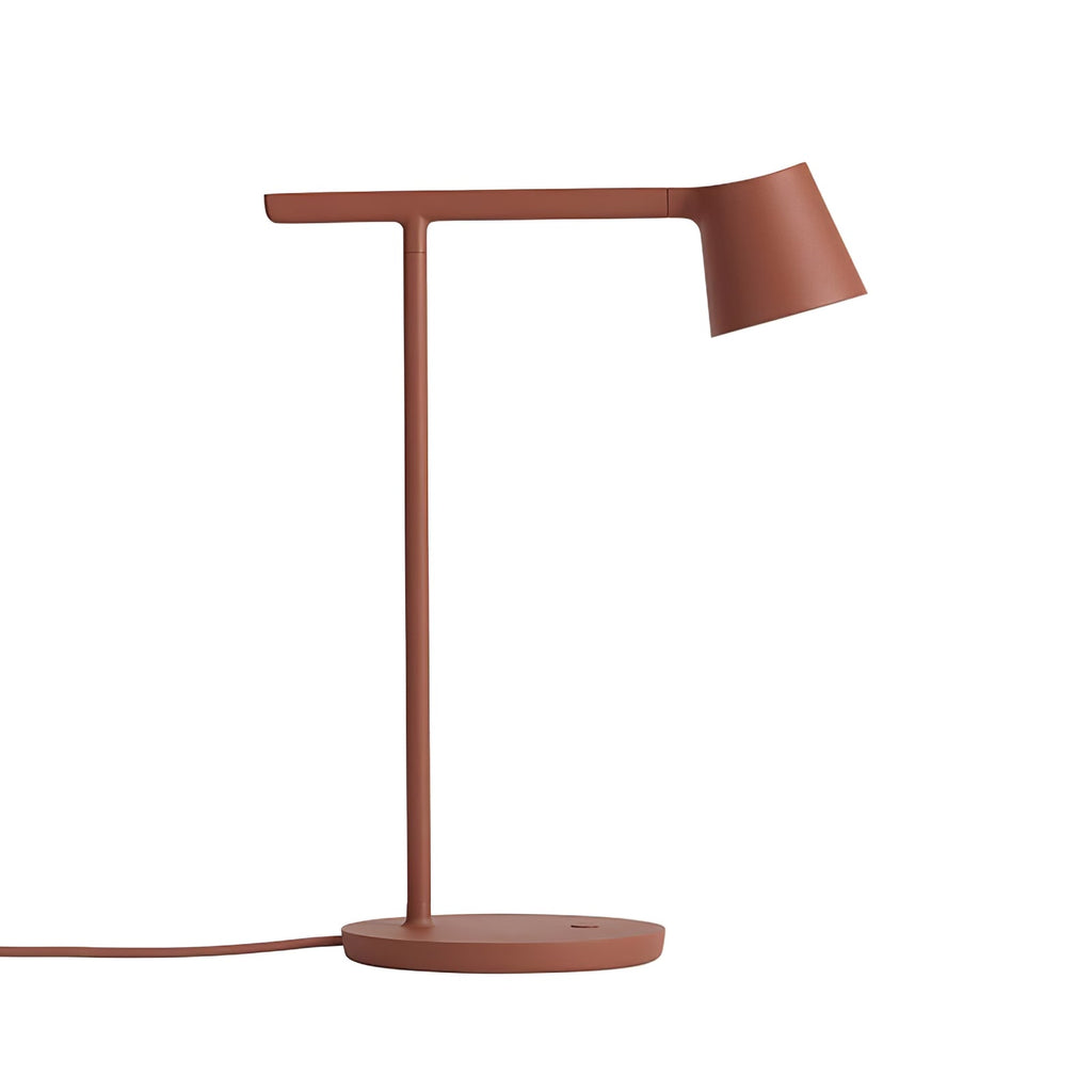 Rust-red Clérachic table lamp at full size on a white backdrop, with its cord curving to the left of the base.