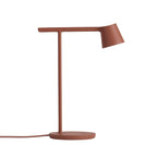 Rust-red Clérachic table lamp at full size on a white backdrop, with its cord curving to the left of the base.