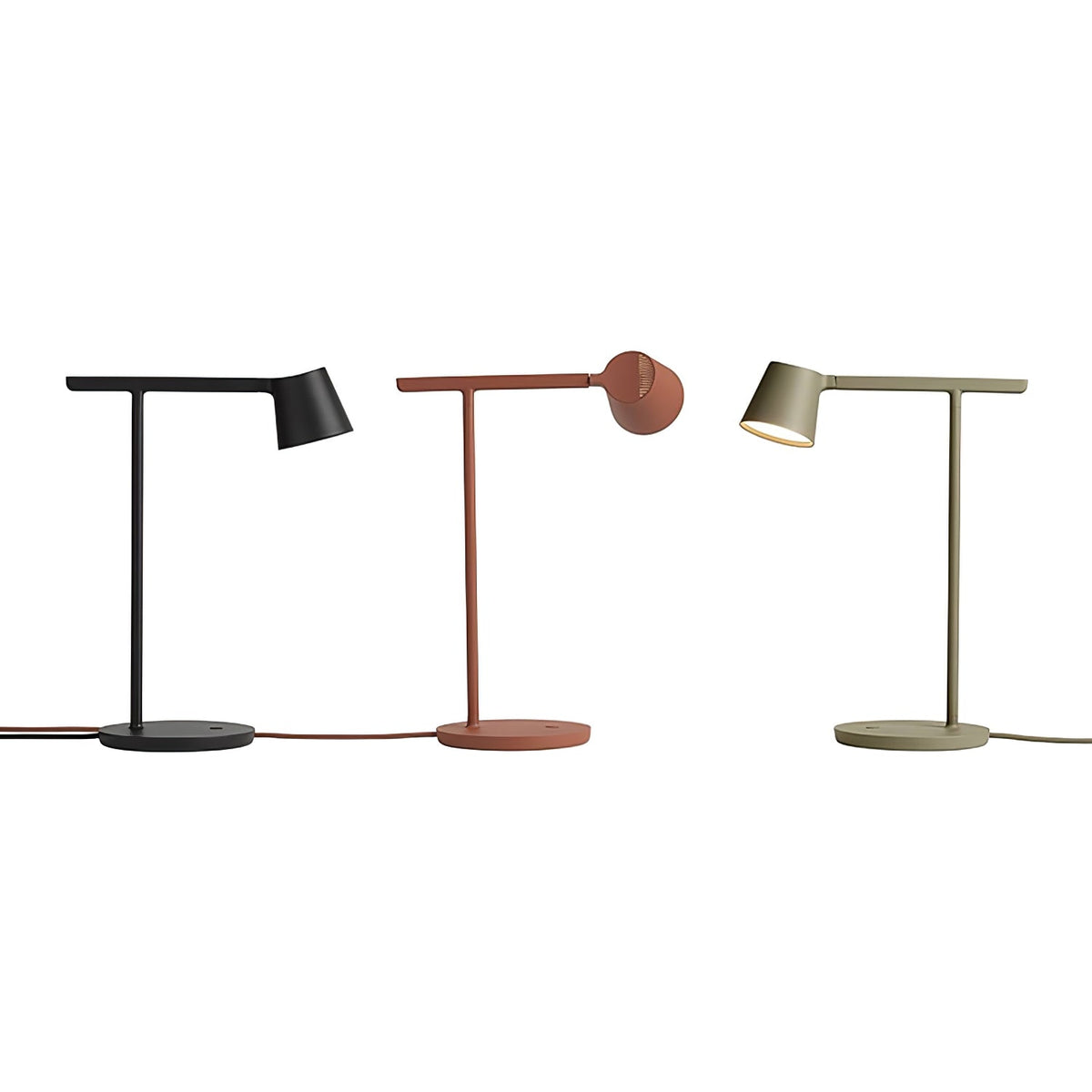 Black, rust-red and olive Clérachic table lamps in a row on white, the red lamp's head turned away.