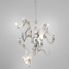White Clérachic monkey chandelier on its hanging chain against a soft grey studio backdrop, with its bulbs unlit.