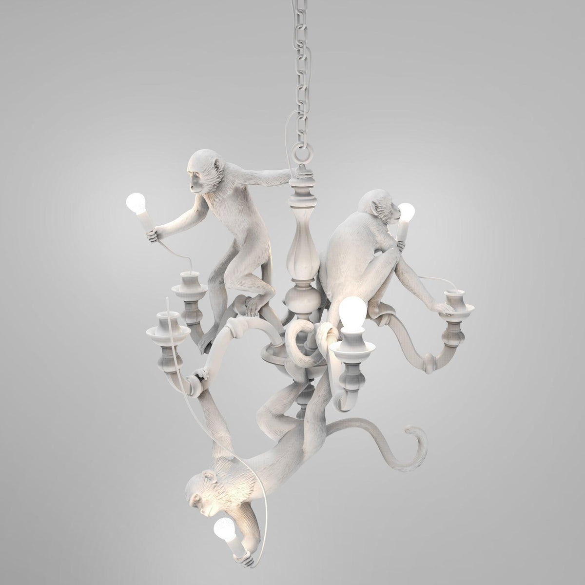 White Clérachic monkey chandelier on its hanging chain against a soft grey studio backdrop, with its bulbs unlit.