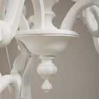 Close view of the round bowl and urn-shaped finial at the base of this white Clérachic chandelier.