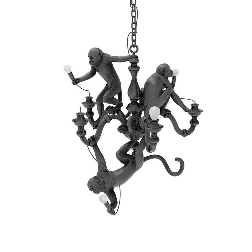 Black Clérachic monkey chandelier on its chain, with one monkey hanging below the arms and the others on the stem, on white.