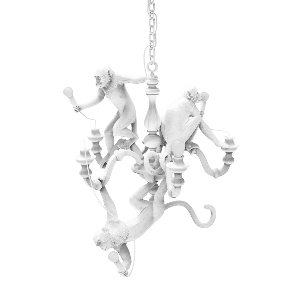 White Clérachic monkey chandelier on a plain white background, its curved arms and three monkeys seen from the front.