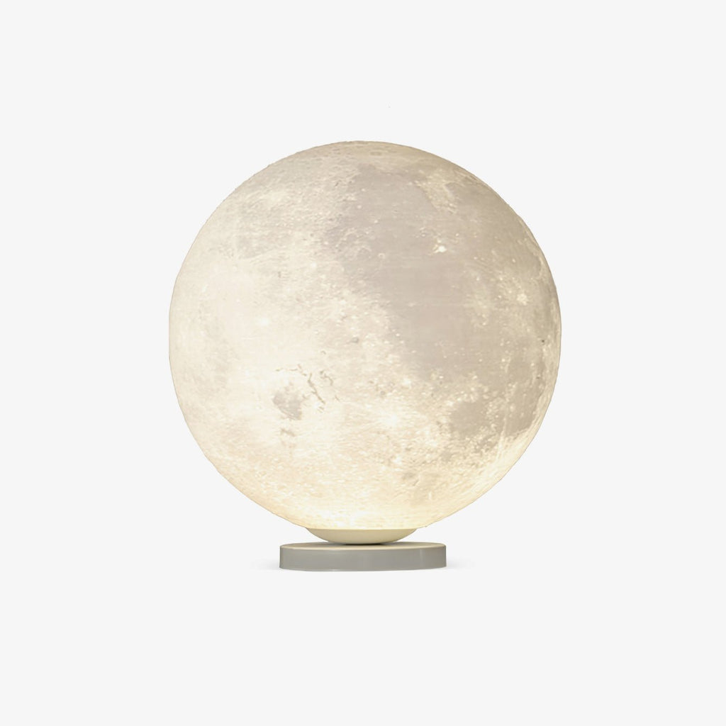 Clérachic moon table lamp, a white sphere with a cratered surface glowing warm on a slim round base, on a plain light backdrop.