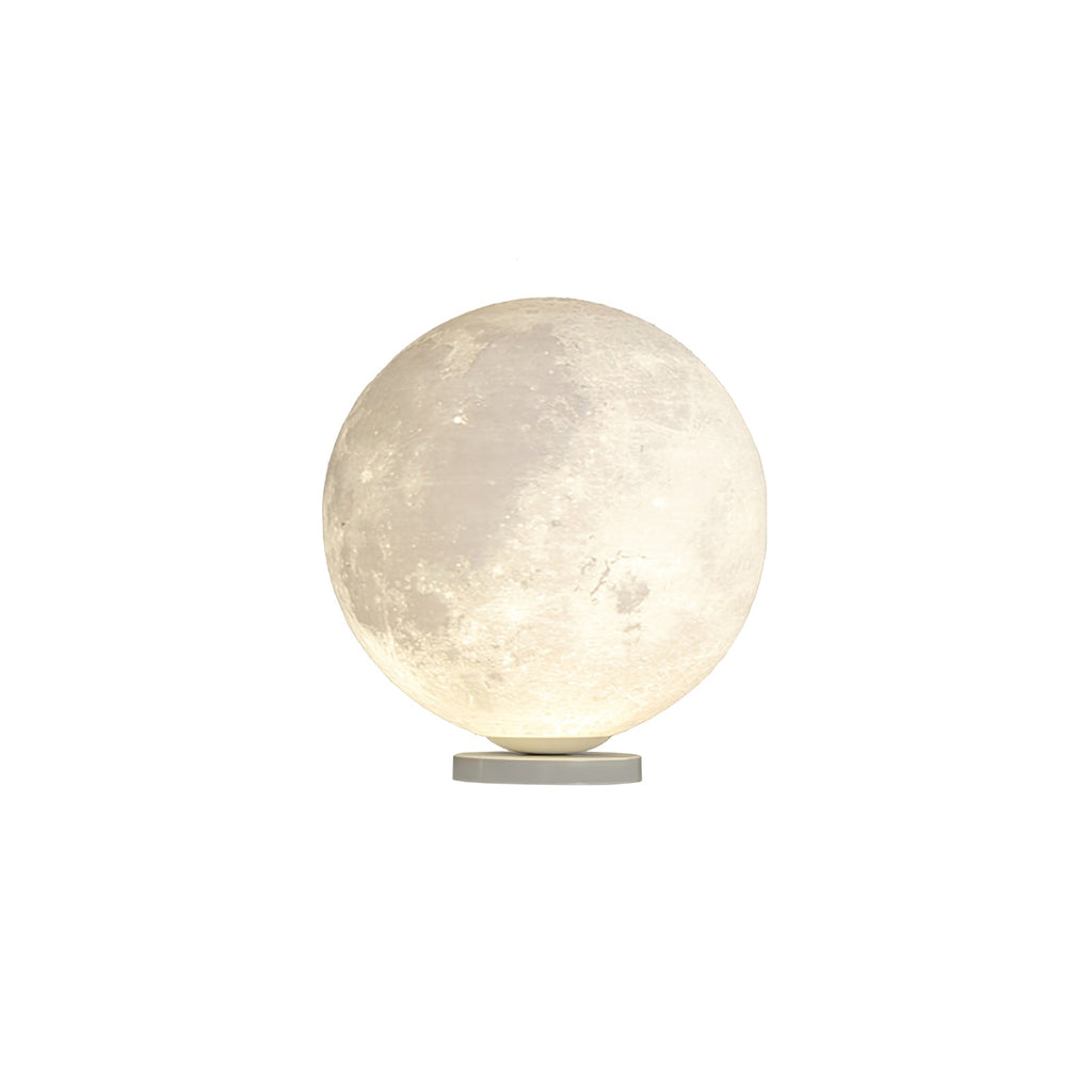 Medium-sized Clérachic moon lamp, lit, with grey maria markings over a warm white surface on a slim base, on white.