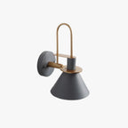 Studio view of the Clérachic Morandi horn-shade wall sconce in gray, showing the brass arch, tilting arm and round backplate.