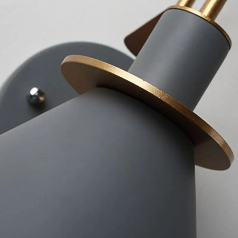 Close-up of the Clérachic Morandi horn-shade wall sconce showing the brushed brass collar ring where the grey cone meets the socket housing.