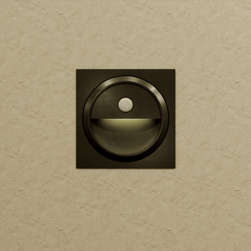 Clérachic black square stair light on a textured sand wall, giving off a faint glow from its half-moon recess.