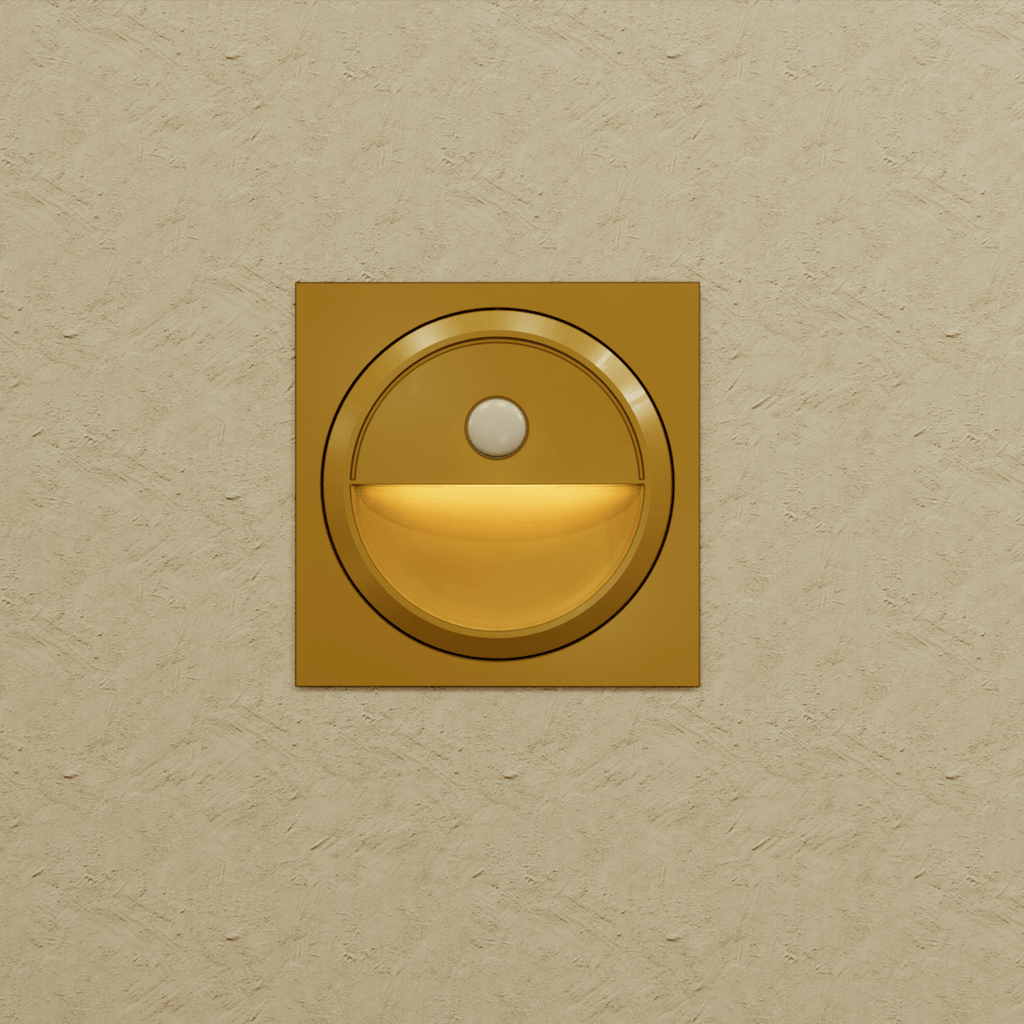 Clérachic gold square stair light on a textured sand wall, its half-moon recess lit in a warm amber glow.