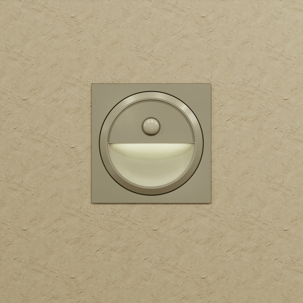 Clérachic silver square stair light on a textured sand wall, its half-moon recess lit a soft warm white.