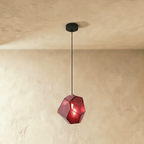 This Clérachic pendant's rose red faceted glass glows from within, the bulb visible through its angled panes.