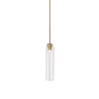 Clear glass tube shade of the Clérachic pendant light, lit on a brass rod, the filament visible through the glass.