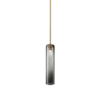 Smoke grey glass on the Clérachic tube pendant, lit on a brass rod, darkest at the top and fading toward the base.