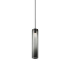 The smoke grey Clérachic glass tube pendant lit on a black rod, its dark collar meeting the stem at the top.