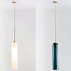 Frosted white and green glass versions of the Clérachic tube pendant shown side by side on matching brass rods.