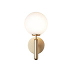 Shown from a slightly different angle, this brass Clérachic wall light's white glass globe stands against a plain white background.