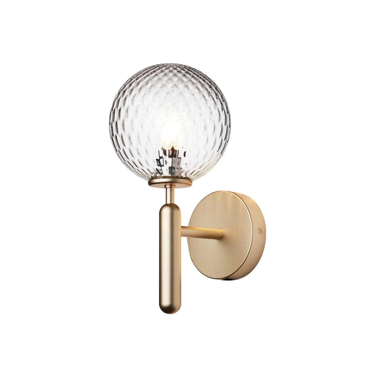 Softly glowing, this brass Clérachic wall light's dimpled clear glass globe stands out against a plain white background.