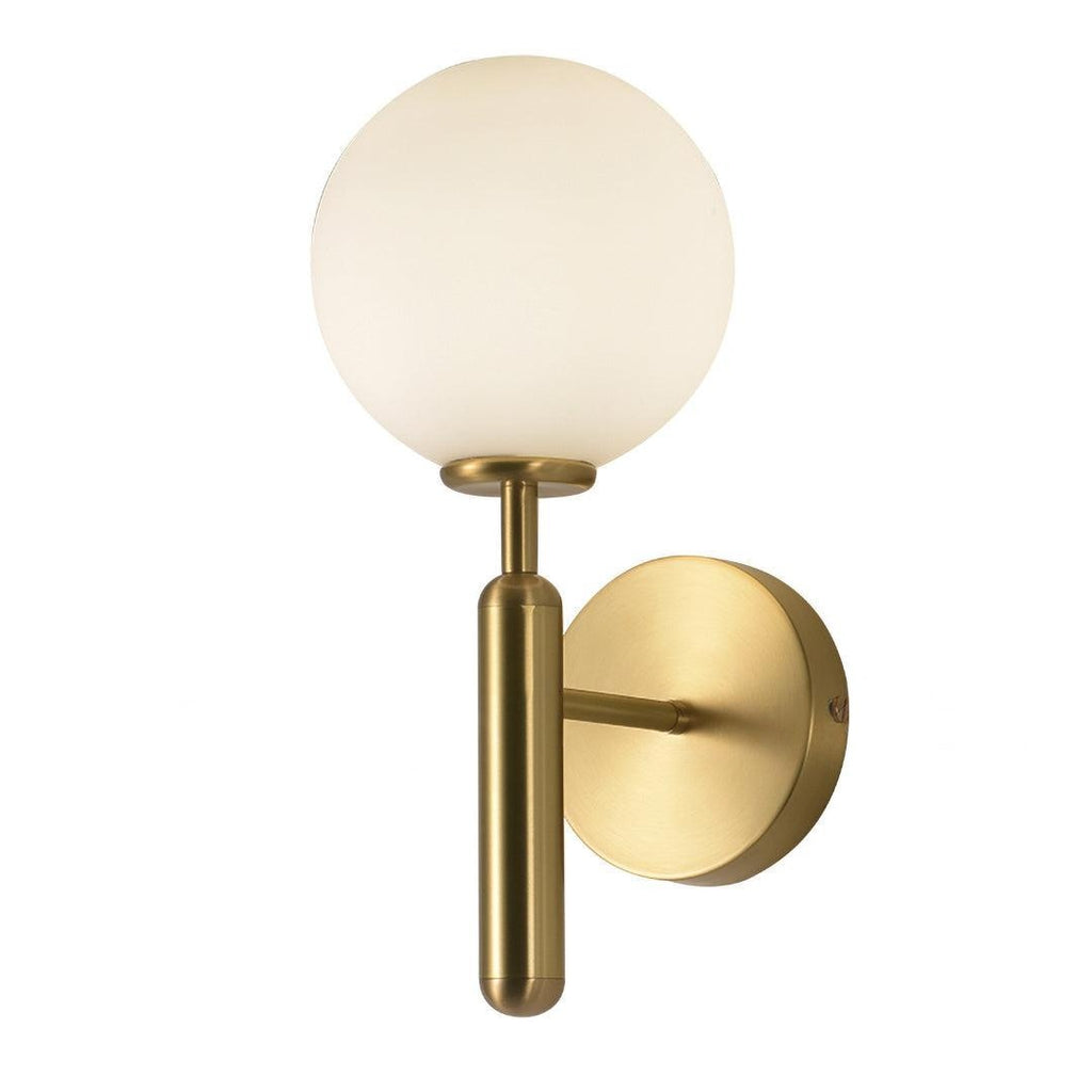 Photographed head-on, this brass Clérachic wall light's white glass globe and mounting plate sit against a plain white background.