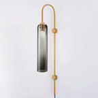 Smoke grey glass on the Clérachic mouth-blown wall sconce, its gold rod fixed to the wall at two points down its length.