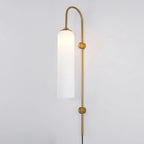 Frosted white glass on the Clérachic mouth-blown wall sconce in gold, softening the bulb to a broad band of light.