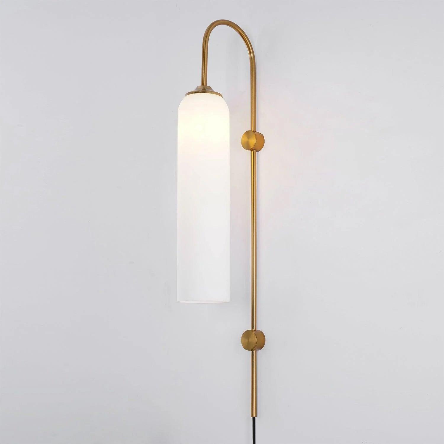 Frosted white glass on the Clérachic mouth-blown wall sconce in gold, softening the bulb to a broad band of light.