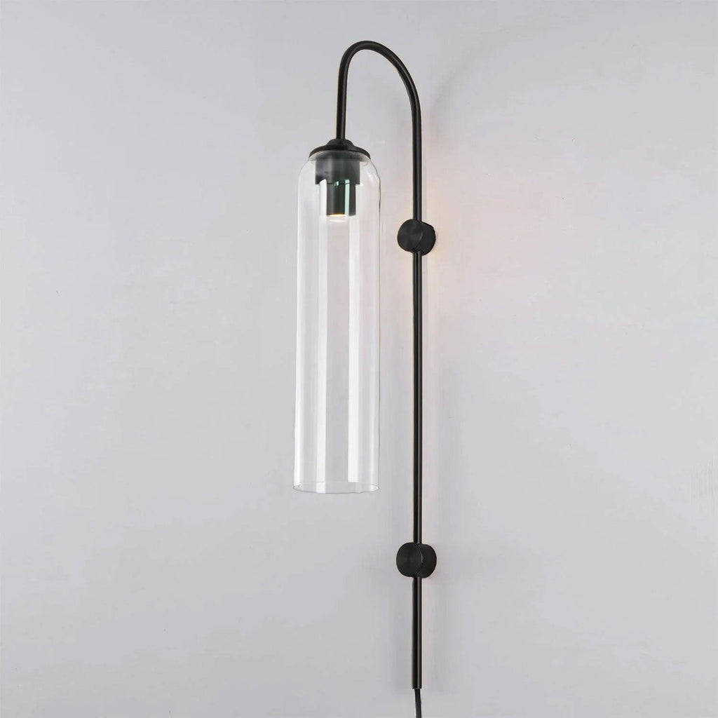 Clear glass on the Clérachic mouth-blown wall sconce with a black body, the metal sleeve visible at the top of the cylinder.